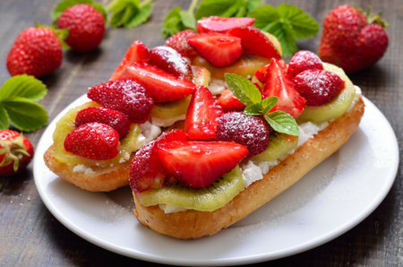 Strawberry bruschetta with kiwi and cream cheese. Easy summer dessertの写真素材