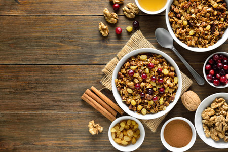 Granola in bowl over wooden background with copy space. Top view, flat lay