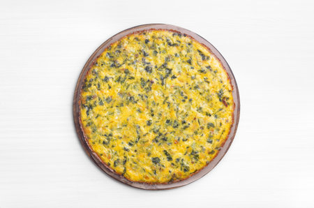 Omelet with herbs over white background. Top view, flat lay