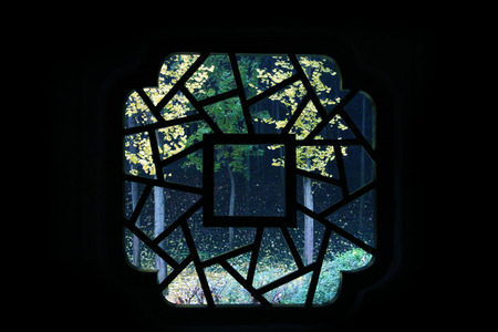 View of outdoor scenery from a traditional Chinese windowの写真素材