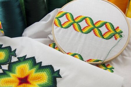 Colorful geometric pattern embroidered in the hoop on a background thread
