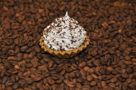 Cake with cream on background spilled coffeeの写真素材