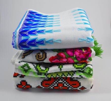 pile of embroidered towels on a white backgroundの写真素材