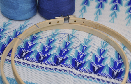 Detail of embroidery products with  blue thread ,wooden hoop, macroの写真素材