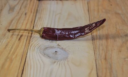The hot pepper on a wooden tableの写真素材