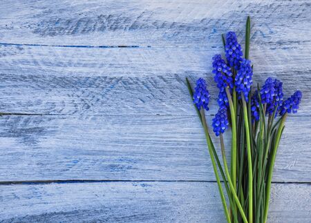 Horizontal background with a bouquet of blue flowers on a wooden backgroundの写真素材