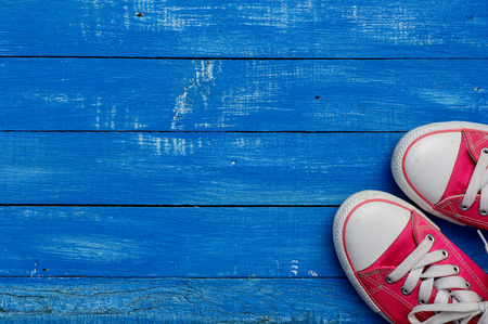 pair of pink sneakers on a wooden floor vintageの写真素材