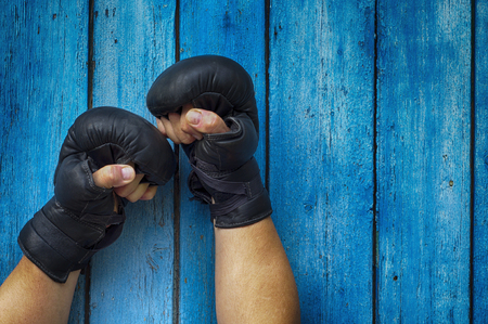 Two hands clenched in a fist gloves for boxingの写真素材