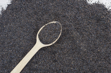 Dried black tea in wooden spoon, top viewの写真素材