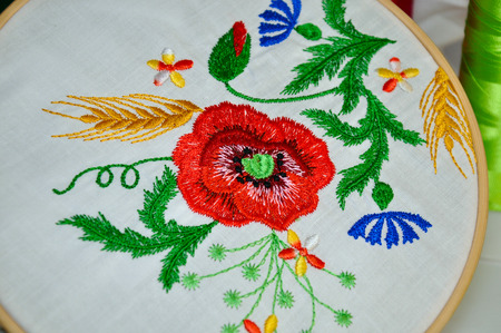 Detail of traditional folk embroidery flower ornament in wooden hoopの写真素材