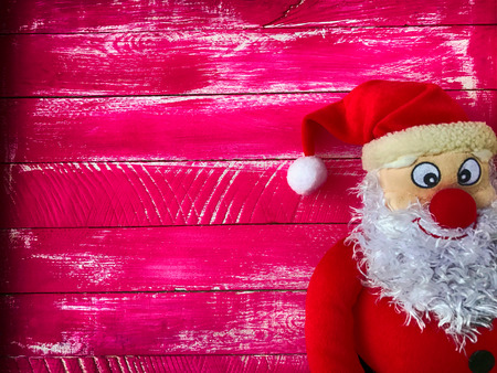 Christmas Santa Claus on a background of wooden pink variegated surface, the empty space left, vintage toningの写真素材