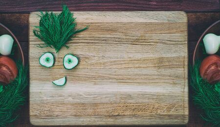 vegetables dietary salad, on the kitchen board smiley cucumber slices, empty space, top viewの写真素材