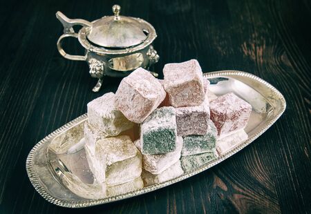 Rose flavoured Turkish delight in traditional silver bowl on wooden  background, vintage toningの写真素材