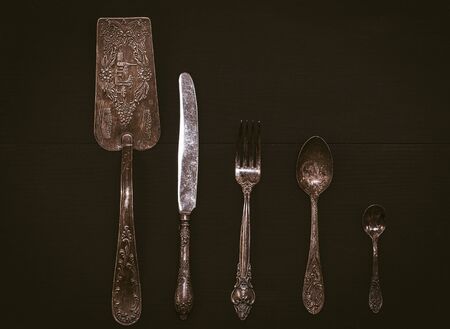 Kitchen accessories on a black wooden surface, vintage toningの写真素材