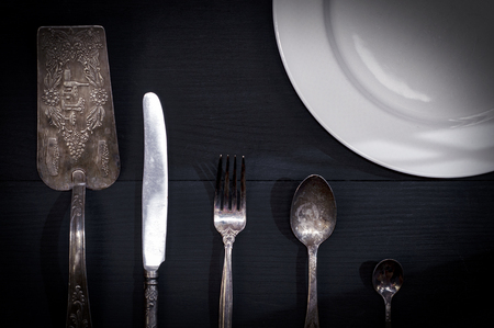 Abstract background with cutlery and plate, black backgroundの写真素材