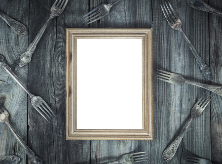 Empty wooden frame on the gray wooden surface, decoration forksの写真素材
