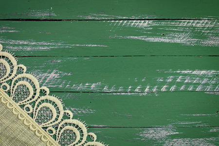 Abstract vintage wooden green background, in a corner of lacy napkinの写真素材