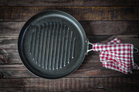 empty pan grill on a wooden surface, the view from the topの写真素材