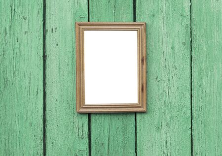 empty wooden frame hanging on green cracked wooden wall, vintage toningの写真素材