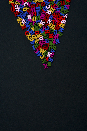 Colored wooden letters on a black surfaceの写真素材