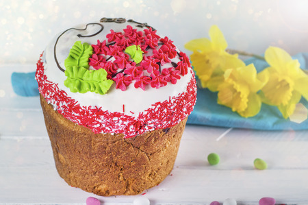 Traditional pastry with icing for a religious Easter holiday, decorated with a pattern of cream and...