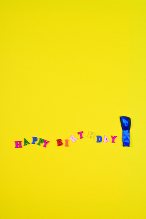 Abstract yellow background with an inscription happy birthday, blank space aboveの写真素材