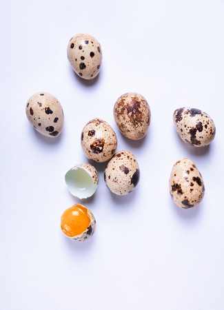 Fresh quail eggs on a white surface, top viewの写真素材