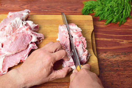 Fresh pork on the chopping board is cut into pieces, the top viewの写真素材