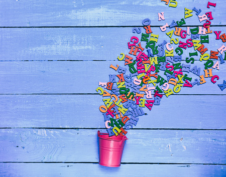 Multicolored wooden letters on a blue backgroundの写真素材