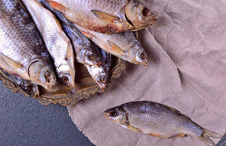 Cured fish carp on an iron plate, top viewの写真素材