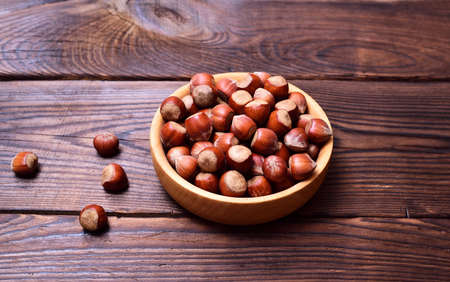 Hazelnut in a wooden plate, top view