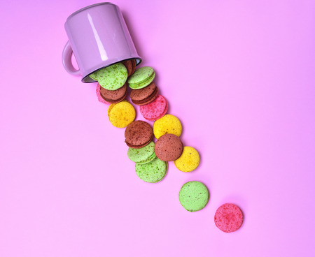 Colorful pastry made of egg whites and almond flour on a pink background, French cookies macaronの写真素材