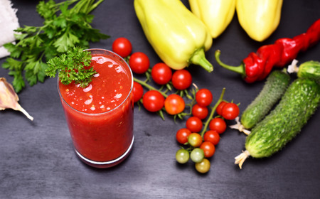 Freshly made juice of tomato and spices in a glass beaker, top view, selective focusの写真素材