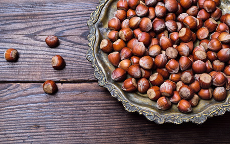 Hazelnuts on an iron plate, empty space on the left