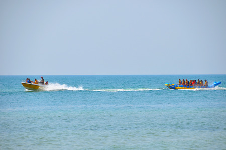 Village Lazurnoe of the Kherson area, Ukraine, August 18, 2017: smiling group of people in vests riding on inflatable structures on a summer dayのeditorial素材