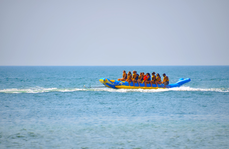 Village Lazurnoe of the Kherson area, Ukraine, August 18, 2017: smiling group of people in vests riding on inflatable structures on a summer dayのeditorial素材
