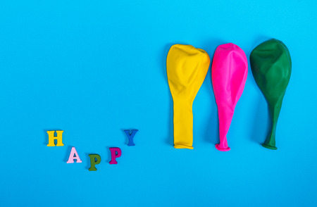 three blown balloons and an inscription happyの写真素材