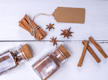 cinnamon stick, cinnamon powder and spice star anise on white wooden background, top viewの写真素材