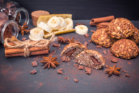 cookies of oatmeal with chocolate on a black background, close upの写真素材
