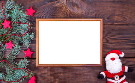Empty wooden frame on a brown background and textile Santa Claus