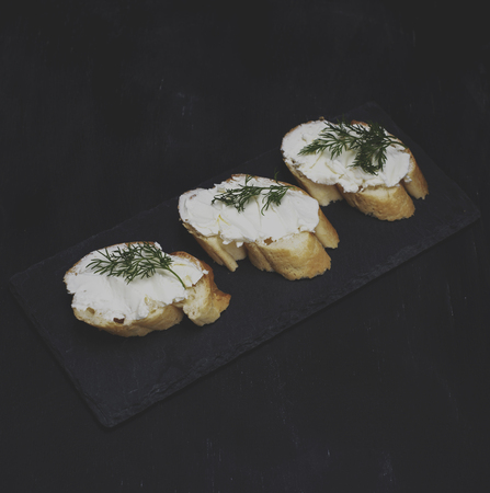 sandwiches with cream cheese on a black background, top viewの写真素材