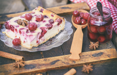 piece of cottage cheese cake and cherry berries on a glass plate and canned cherry berries, vintage...
