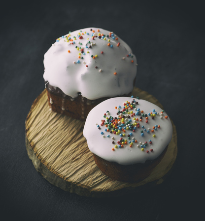 traditional Easter baking of Ukraine with white sugar icing and colorful decor, top view