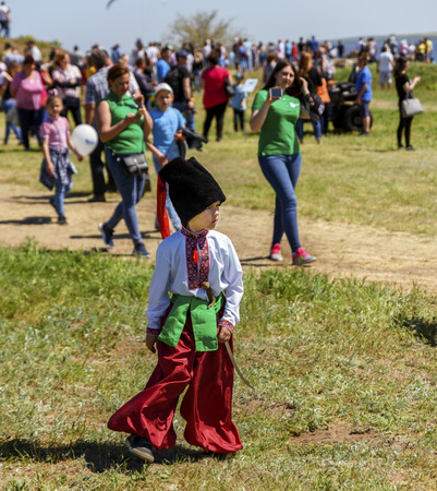 Kherson, Berislavsky district, Republicanets village, National nature park Kam'janska Sich , UKRAINE - APRIL 30, 2018: little boy in national Ukrainian clothes of red trousers and an embroidered shirtのeditorial素材