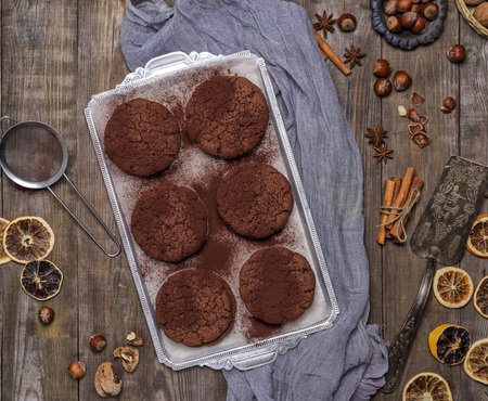 baked round chocolate chip cookies on a silver plate, top view