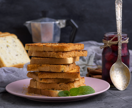a stack of fried square slices of bread on a ceramic plate, French toast