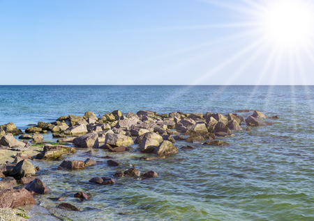 View of the Black Sea with large stones on a summer sunny day, the village of Iron Port Ukraineの写真素材