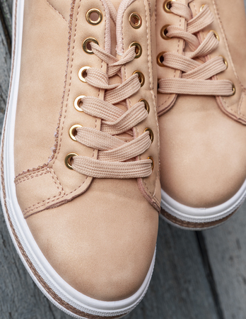 fragment of beige leather women's shoes with laces, close upの写真素材