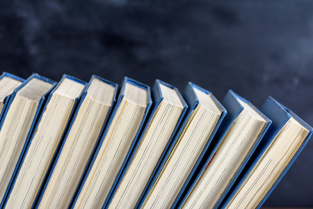 books with blue cover, black background, empty spaceの写真素材