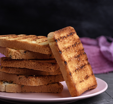 fried French toast on a ceramic pink plate, close up